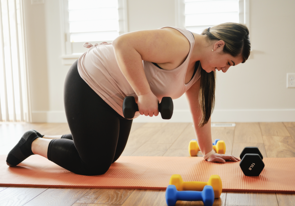 a woman exercising on wooden floor