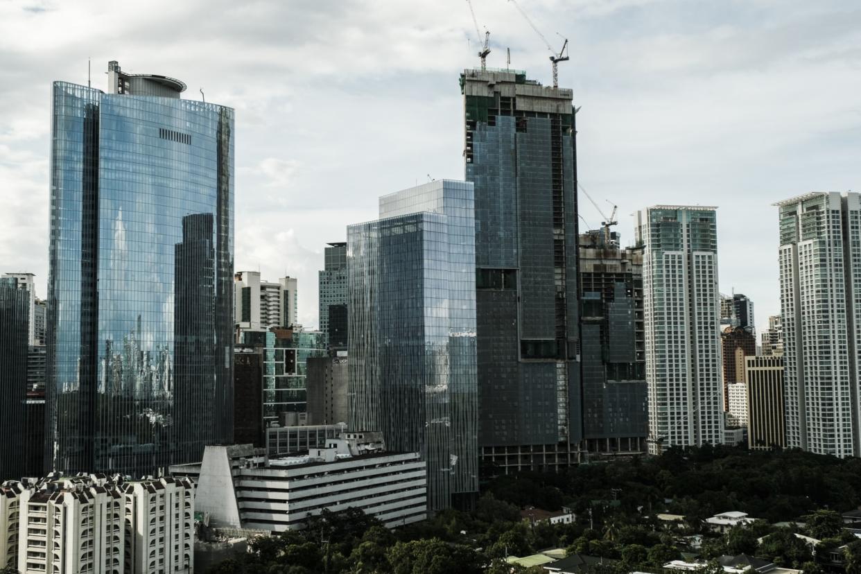 Buildings in the Central Business District (CBD) in Makati City, the Philippines, on Tuesday, Aug. 16, 2022. The Philippine central bank will sustain its rate-hike cycle this quarter, following a surprise move in July, to quell broadening price pressures, according to a Bloomberg survey of economists. The benchmark interest rate is expected to increase by another 75 basis points to 4% by the end of September, a survey showed. Photographer: Veejay Villafranca/Bloomberg