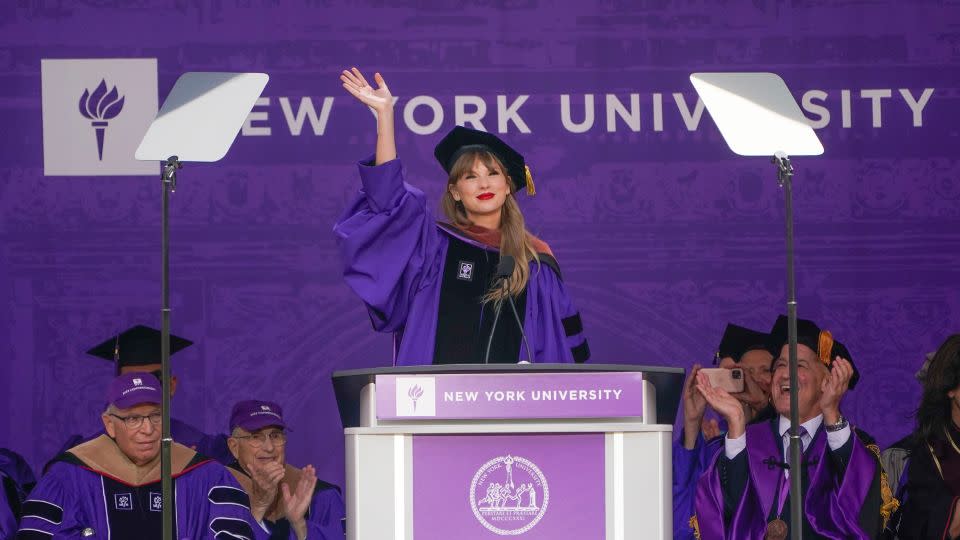 Taylor Swift waves after speaking during a graduation ceremony for New York University in May 2022. - Seth Wenig/AP