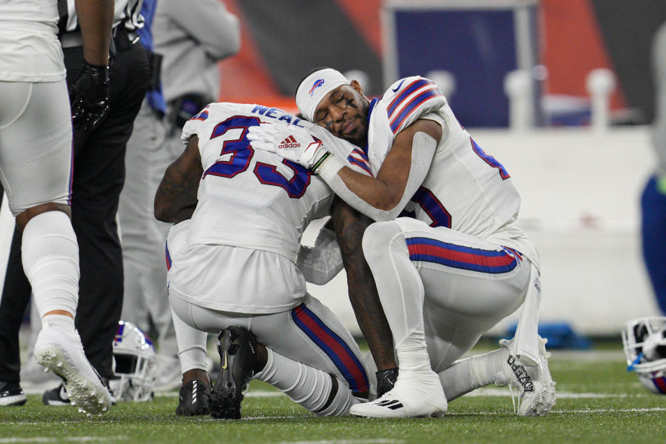 FILE - Buffalo Bills' Siran Neal (33) and Nyheim Hines react after teammate Damar Hamlin was injured during the first half of an NFL football game against the Cincinnati Bengals, Monday, Jan. 2, 2023, in Cincinnati. On Jan. 2, a religious undercurrent was thrust into the NFL spotlight when Buffalo Bills safety Damar Hamlin collapsed during a crucial game with Cincinnati. Those watching witnessed players praying on the field as medics worked to save Hamlin’s life.(AP Photo/Jeff Dean, File)