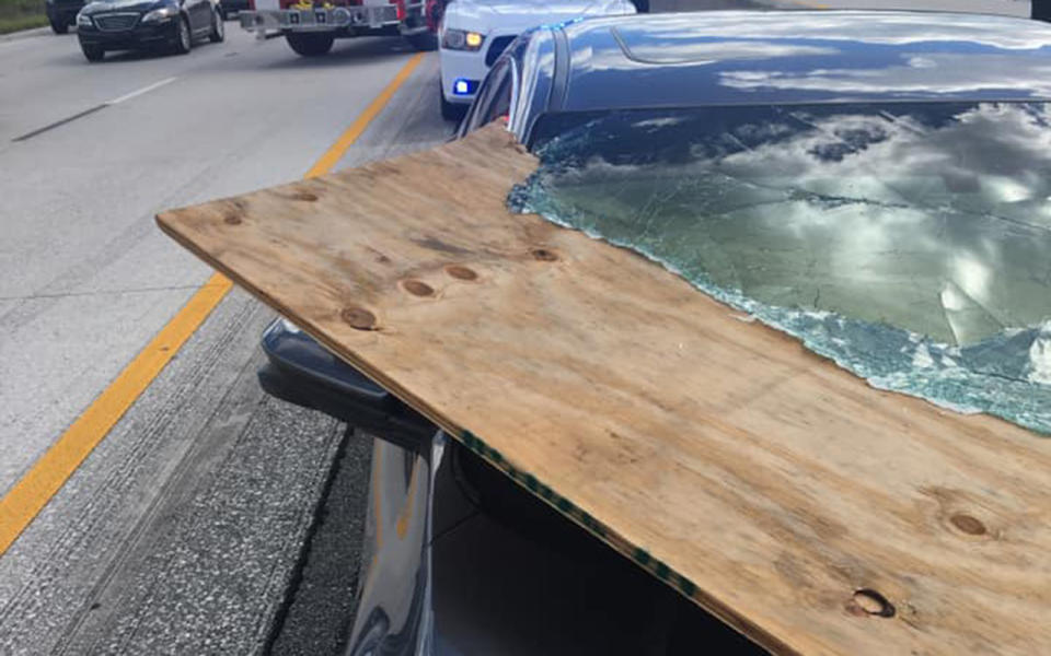 The plywood narrowly missed the driver. Image: Brevard County Fire Rescue