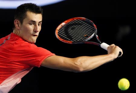 Australia's Bernard Tomic hits a shot during his third round match against compatriot John Millman at the Australian Open tennis tournament at Melbourne Park, Australia, January 24, 2016. REUTERS/Brandon Malone