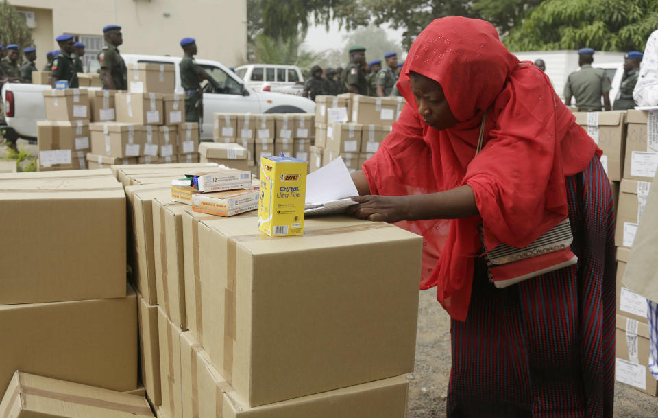 An electoral worker takes stock of ballot papers to be transporters at the offices of the Independent National Electoral Commission in Yola, Nigeria, Friday, Feb. 15, 2019. Nigeria surged into the final day of campaigning ahead of Saturday's election, as President Muhammadu Buhari made one last pitch to stay in office while top challenger Atiku Abubakar shouted to supporters: "Oh my God! Let them go! Let them go!" (AP Photo/Sunday Alamba)