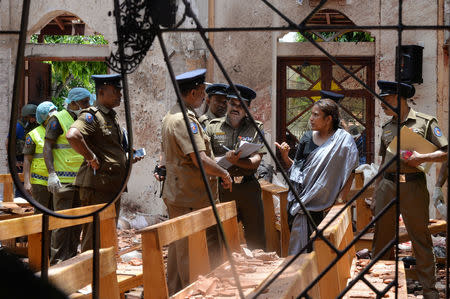 Crime scene officials inspect the site of a bomb blast inside a church in Negombo, Sri Lanka April 21, 2019. REUTERS/Stringer