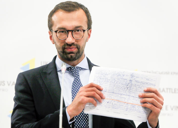 FILE - In this Aug. 19, 2016, file photo, Serhiy Leshchenko, a former investigative journalist turned lawmaker shows a copy one of the once-secret accounting documents of Ukraine's pro-Kremlin party that were released and purport to show payments earmarked for then-Donald Trump's campaign chairman Paul Manafort, during a news conference in Kiev, Ukraine. A firm headed by Manafort received more than $1.2 million in payments that correspond to entries in the handwritten ledger tied to a pro-Russian political party in Ukraine, according to financial records obtained by The Associated Press. The payments between 2007 and 2009 are the first evidence that Manafort’s consulting firm received funds listed in the so-called Black Ledger, Ukrainian investigators have been investigating as evidence of off-the-books payments from the Ukrainian Party of Regions. (AP Photo/Efrem Lukatsky, File)