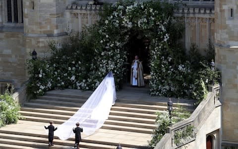 John and Brian Mulroney carry the Duchess' veil - Credit: PA