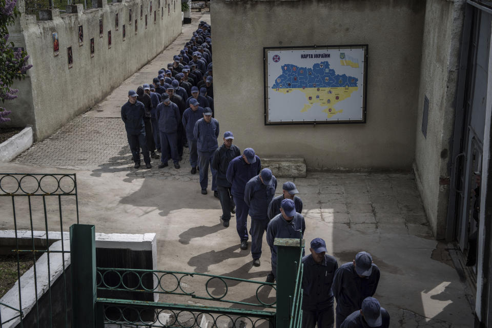 Captured Russian soldiers walk in line to a dining room at the prisoner of war detention center in Ukraine's Lviv region, Thursday, April 25, 2024. AP visited the center as part of a small group of journalists on the condition that its exact location be withheld. (AP Photo/Evgeniy Maloletka)