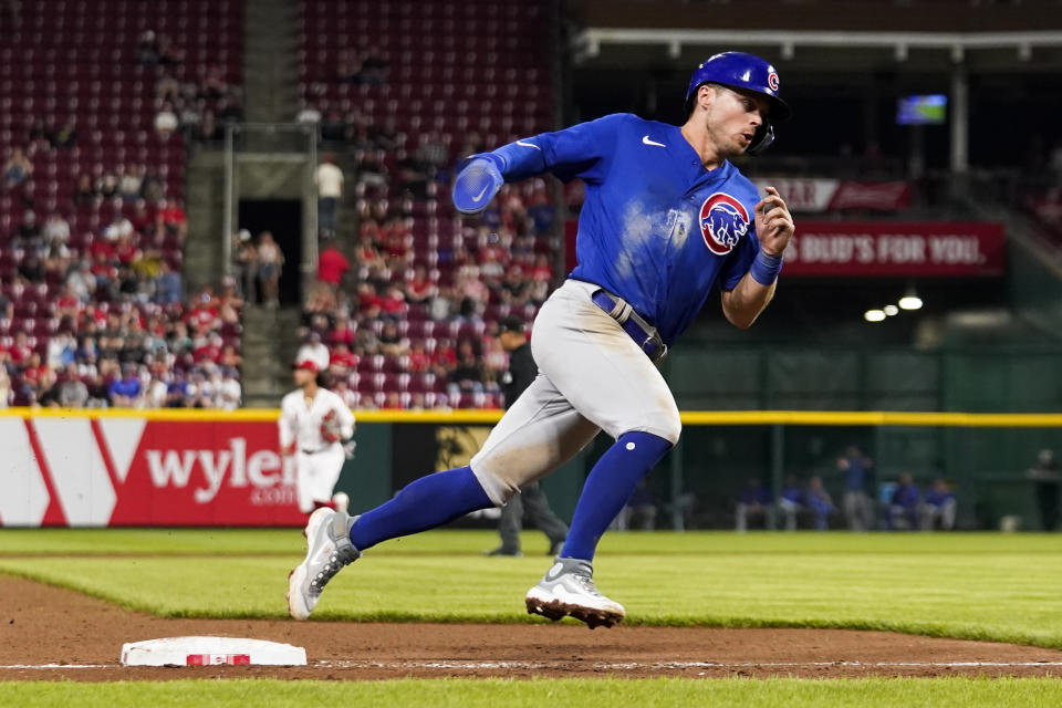 Chicago Cubs' Nico Hoerner rounds third base and scores on an Ian Happ double in the seventh inning of a baseball game against the Cincinnati Reds in Cincinnati, Tuesday, April 4, 2023. (AP Photo/Jeff Dean)
