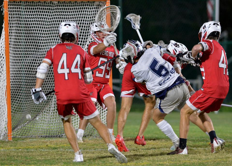 Luke Herrman (6), of St. Edward's School, shoots to score as Vero Beach goalkeeper Jack Wilson (99) attempts to block during a boy's high school lacrosse game, Tuesday, Feb. 28, 2023, in Indian River County. St. Edwards won 16-3.