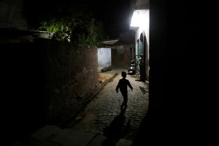 FILE PHOTO: A Muslim boy arrives at a mosque for the morning prayer during the holy month of Ramadan in village Nayabans in the northern state of Uttar Pradesh, India May 10, 2019. REUTERS/Adnan Abidi