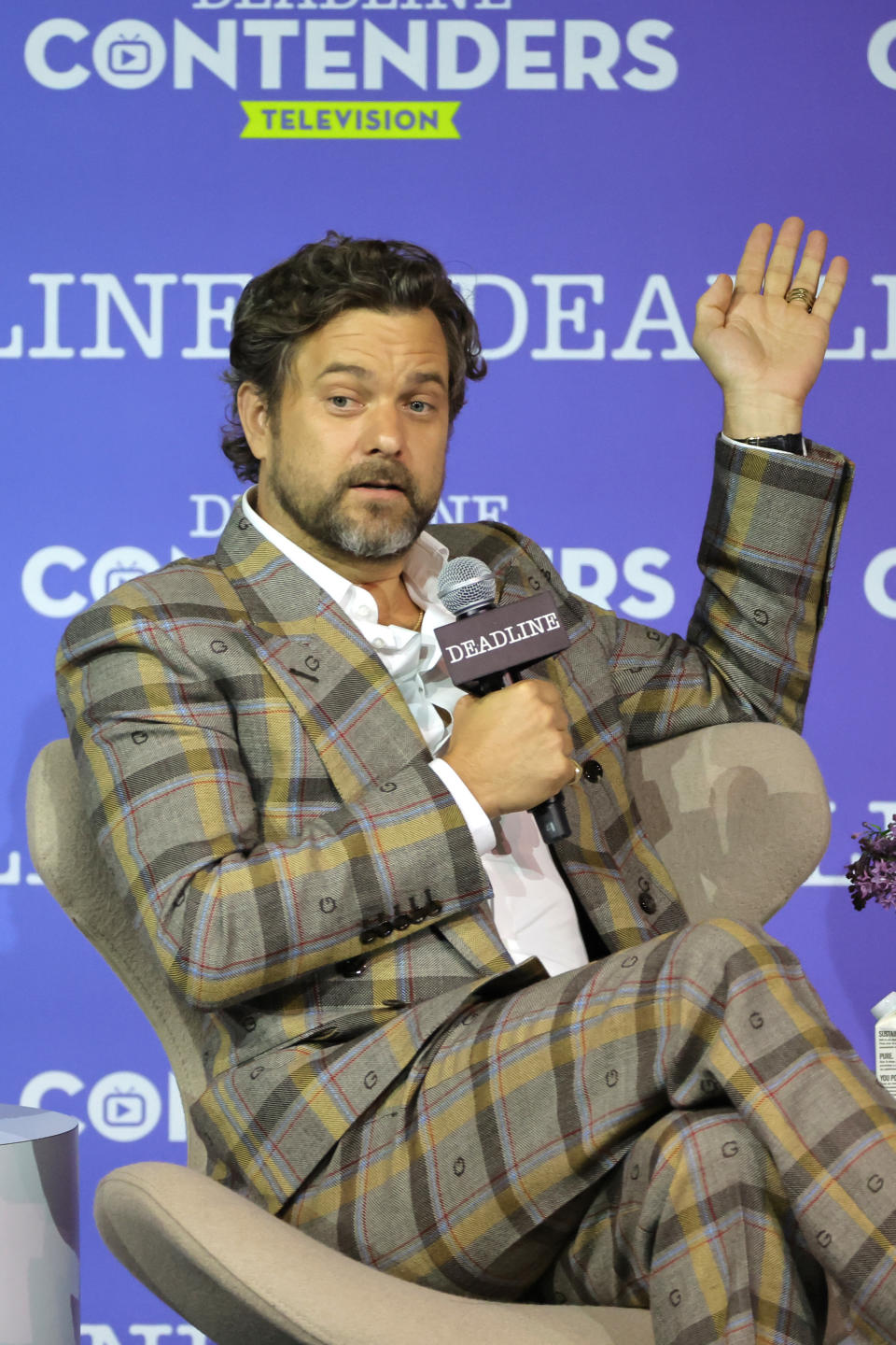 Joshua in a striped suit and sitting during an interview