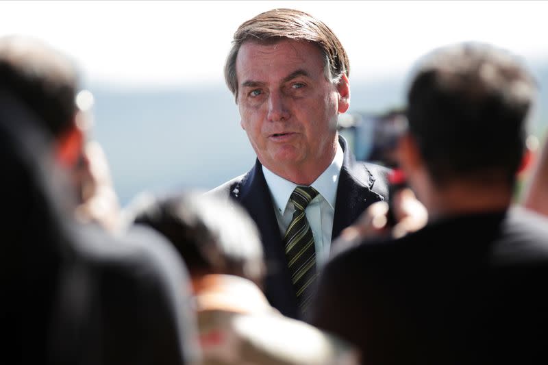 Brazil's President Jair Bolsonaro meets supporters as he leaves Alvorada Palace, as the spread of coronavirus disease (COVID-19) continues, in Brasilia