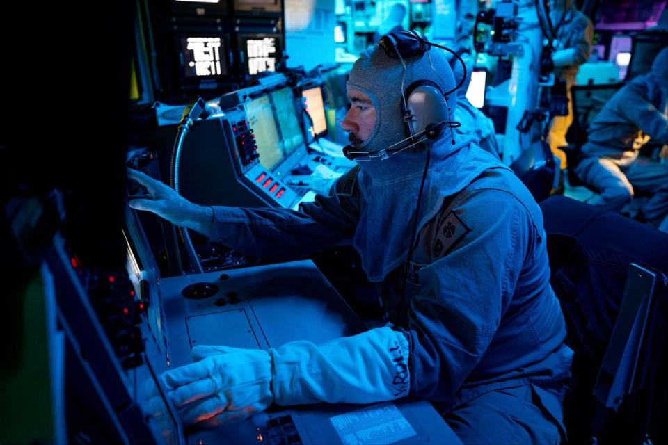 Chief Fire Controlman (Aegis) Kenneth Krull, assigned to the USS Carney (DDG 64), mans the combat systems coordinator console in the combat information center during a general quarters drill (AP)