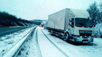 <p>Picture taken with permission from the twitter feed of @simontab of stuck lorries between J2 and J1 after overnight snow caused travel disruptions across parts of the UK. (PA) </p>