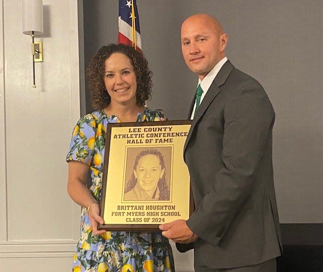 Former Fort Myers High softball star Brittani Houghton was among eight members of the Lee County Athletic Conference Hall of Fame's Class of 2024. With her is Fort Myers principal Christian Engelhart.