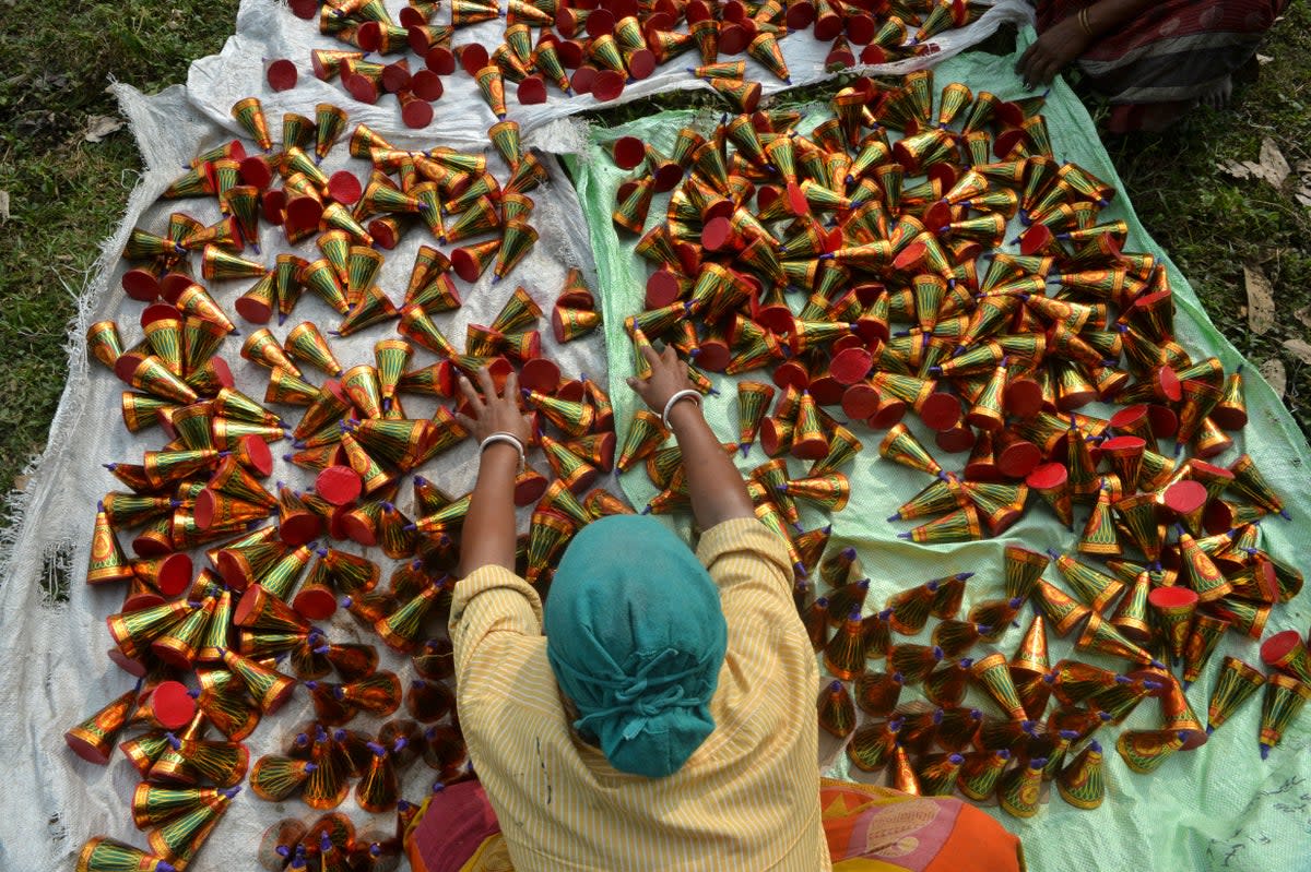 File A labourer works on eco-friendly crackers, which produce less smoke and contain less chemicals, at Raj firecracker factory in Liusipukuri village, on the outskirts of Siliguri in 2019 (AFP via Getty Images)