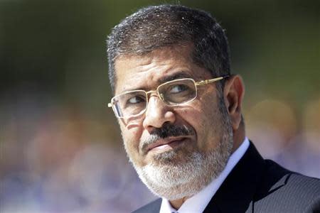 Egypt's President Mohamed Mursi reviews the troops in an official ceremony before a meeting with Brazil's President Dilma Rousseff at the Planalto Palace in Brasilia May 8, 2013. REUTERS/Ueslei Marcelino