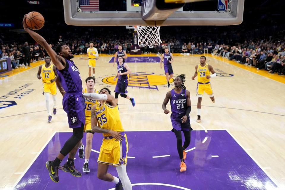 Sacramento Kings guard Malik Monk (0) dunks the ball against the Los Angeles Lakers in the second half Nov. 15, 2023, at Crypto.com Arena in Los Angeles.
