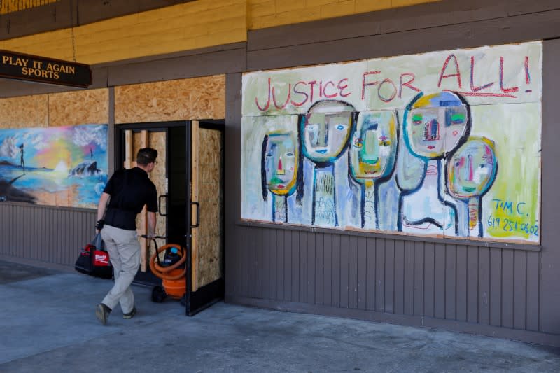 Residents help clean up their small California town after riots and looting