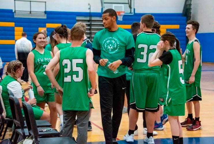 Ohio State's Roddy Gayle helps coach a Unified Sports basketball team at his alma mater, Youngstown (New York) Lewiston-Porter High School.