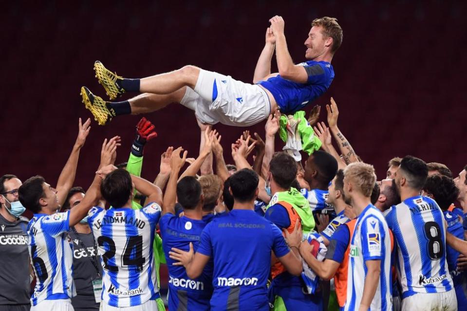 David Zurutuza of Real Sociedad is thrown in the air by his teammates after the match against Atlético Madrid.