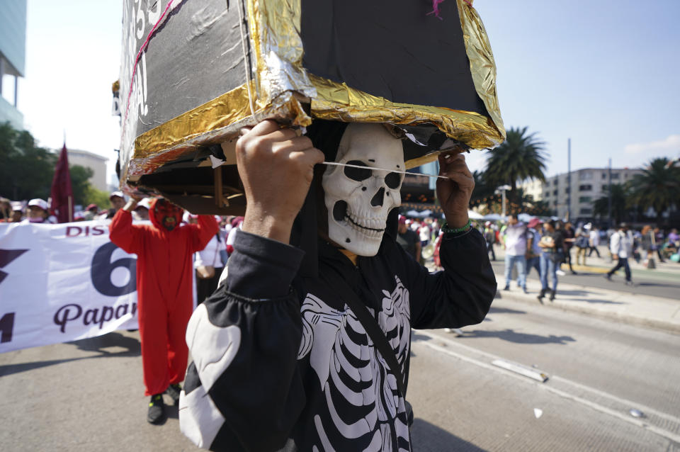 A man wears a skeleton costume during a march to support Mexican President Andres Manuel Lopez Obrador's administration in Mexico City, Sunday, Nov. 27, 2022.(AP Photo/Fernando Llano)