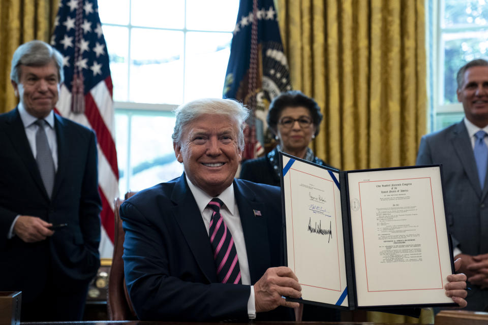 WASHINGTON, DC - APRIL 24: U.S. President Donald Trump participates in a signing ceremony for H.R.266, the Paycheck Protection Program and Health Care Enhancement Act, with members of his administration and Republican lawmakers in the Oval Office of the White House in Washington DC on April 24th, 2020. The bill includes an additional $321 billion for the Paycheck Protection Programs forgivable loans to cover payroll and other costs for small businesses. Hospitals and other health care providers will receive $75 billion and another $25 billion is allocated for COVID-19 testing. (Photo by Anna Moneymaker/The New York Times/POOL/Getty Images)