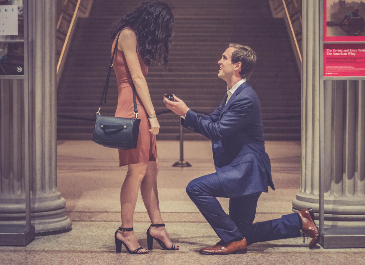 A man proposing to a woman at the Met.