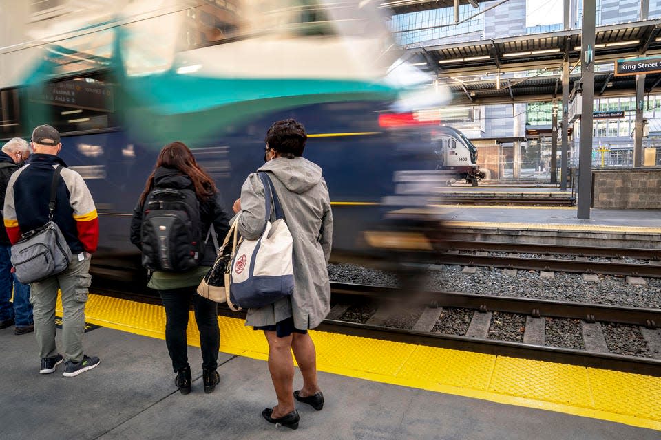 Passengers wait to board a Sounder train at King Street Station on Nov. 15 in Seattle.