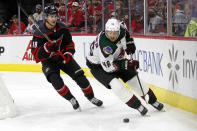 Arizona Coyotes' Ilya Lyubushkin (46) moves the puck in front of Carolina Hurricanes' Martin Necas (88) during the second period of an NHL hockey game in Raleigh, N.C., Sunday, Oct. 31, 2021. (AP Photo/Karl B DeBlaker)