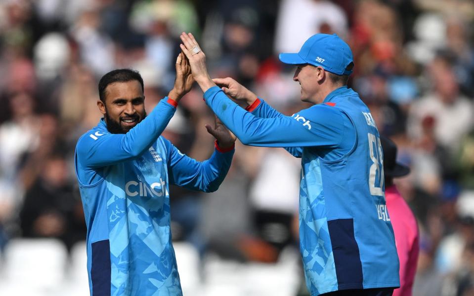 Adil Rashid celebrates his 200th ODI wicket with the England captain Harry Brook