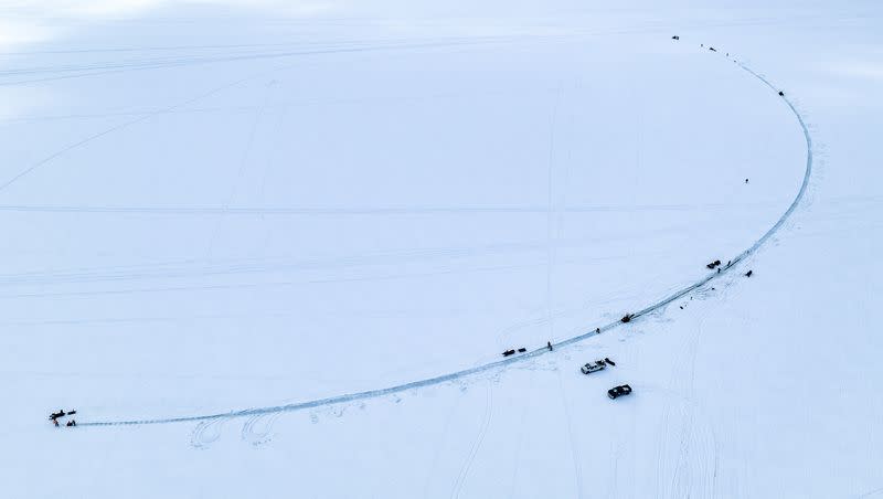 This photo provided by Aroostook UAS shows volunteers creating a giant ice carousel on a frozen lake work on a path curt through the ice on Wednesday, March 29, 2023, on Long Lake in Madawaska, Maine.