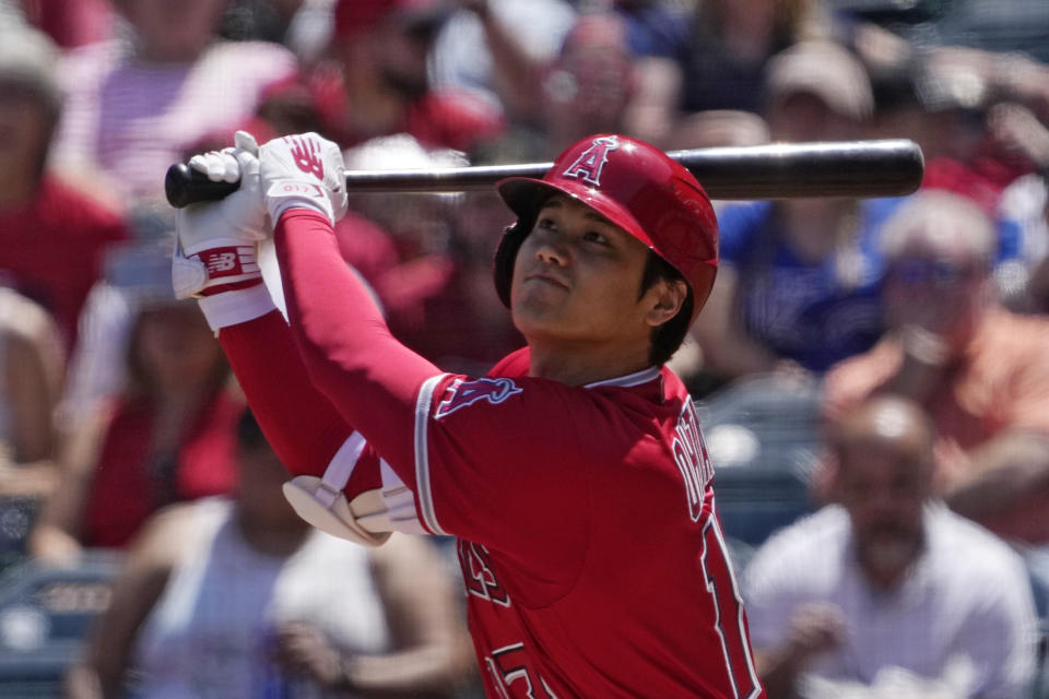 Los Angeles Angels' Shohei Ohtani hits a sacrifice fly during the first inning of a baseball game against the Kansas City Royals Sunday, April 23, 2023, in Anaheim, Calif. Taylor Ward scored on the play. (AP Photo/Mark J. Terrill)