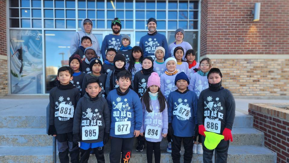 Staff and students of the Cactus Elementary School run club stand after running in the Cold As Ice run Saturday in Amarillo.