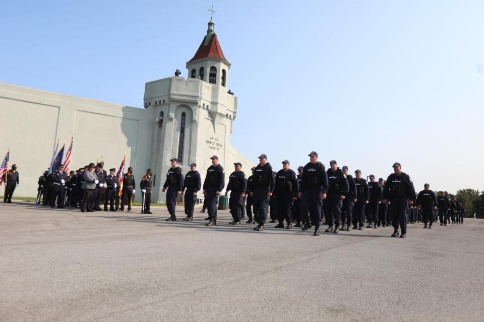 In this file photo, members of the CERT, Correctional Emergency Response Team, from all over the state march in front of Attica Correctional Facility as part of the ceremony for the Forgotten Victims of Attica memorial in front of Attica Correctional Facility on September 13, 2021. On that date in 1971, 50 years ago, New York State Police retook the prison after inmates took control of a portion of the prison, D-Yard, holding hostages. 43 people died during the retaking and one correctional officer, William Quinn died Sept. 11, 1971 as a result of being beaten during the prison uprising. CERT was created in response to the Attica prison riot.
