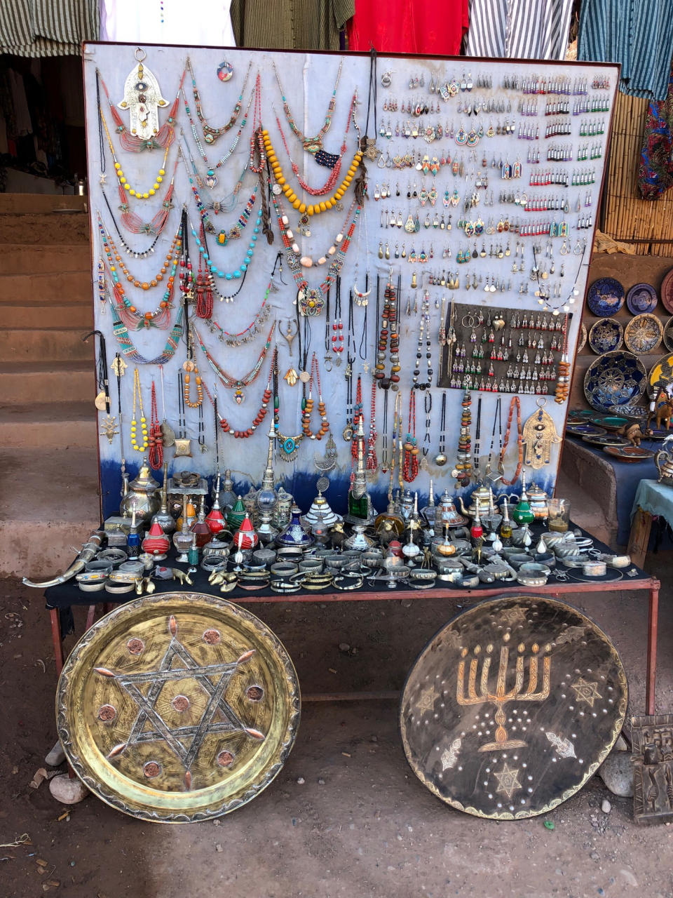 This Jan. 16, 2019, photo shows platters adorned with a menorah and Jewish stars in an outdoor stall near Ksar of Ait-Ben-Haddou in southern Morocco. The North African kingdom once had a thriving Jewish population. Jews of Moroccan descent return often on heritage tours. (Leanne Italie via AP)