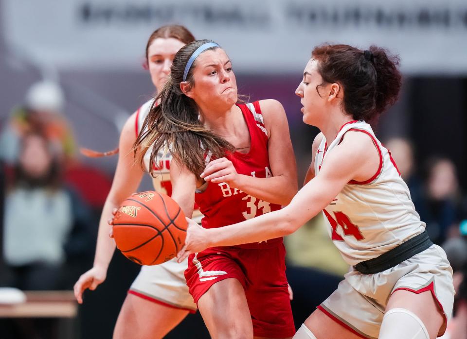 Ballard forward Paige Noe (34) attempts to pass the ball around Dallas Center-Grimes guard Finley Fitzgerald (24) during the class 4A semifinals of the Iowa high school girls state basketball tournament at Wells Fargo Arena on Thursday, March 2, 2023. The Mustangs defeated the Boomers, 33-32.