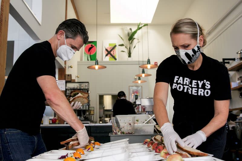 FILE PHOTO: Chris and Amy Hillyard, owners of Farley’s East, pack lunches for World Central Kitchen, amid the coronavirus disease (COVID-19) outbreak, in Oakland, California