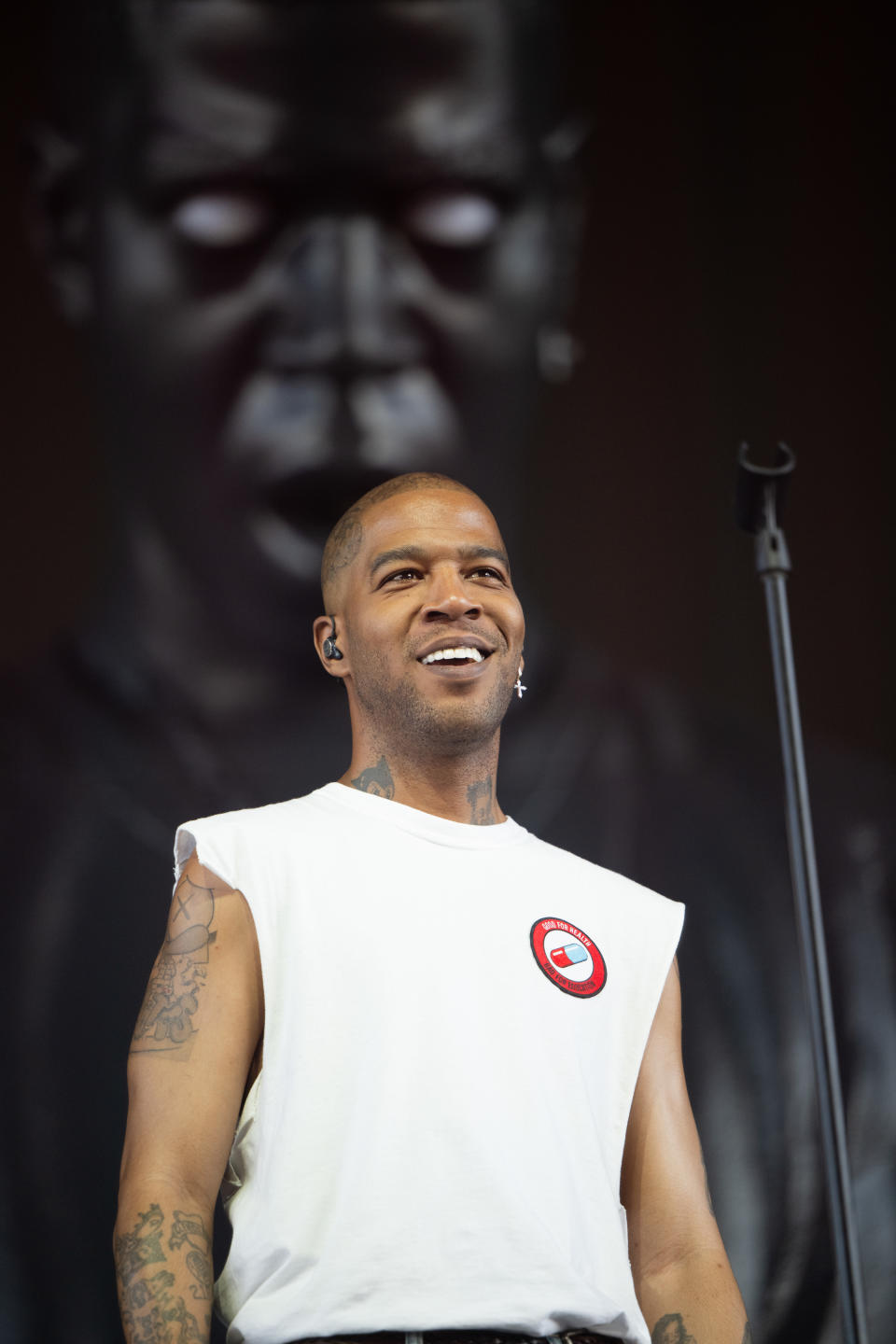 Closeup of Kid Cudi smiling onstage