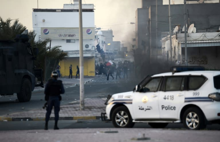 Protesters throw stones at riot police during clashes in the Shiite village of Shahrakkan, south of Manama on April 5, 2016 after the funeral of a 17-year-old whose family says he died of injuries suffered in a police chase