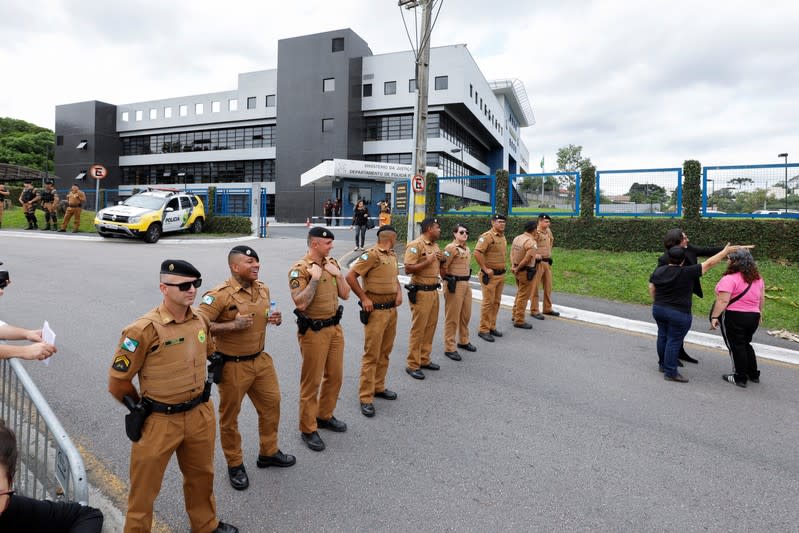 Members of the security forces stand guard and block a road in front of the Federal Police headquarters where Lula is serving a prison sentence, in Curitiba