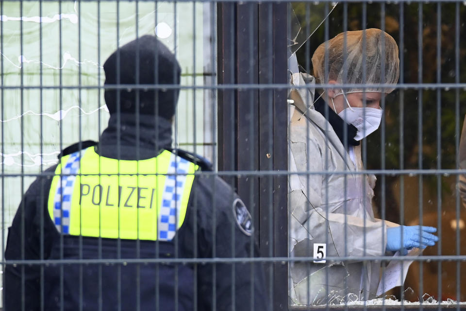 Investigators and forensic experts stand outside a Jehovah's Witness building in Hamburg, Germany Friday, March 10, 2023. Shots were fired inside the building used by Jehovah's Witnesses in the northern German city of Hamburg on Thursday evening, with multiple people killed and wounded, police said. (Jonas Walzberg/dpa via AP)