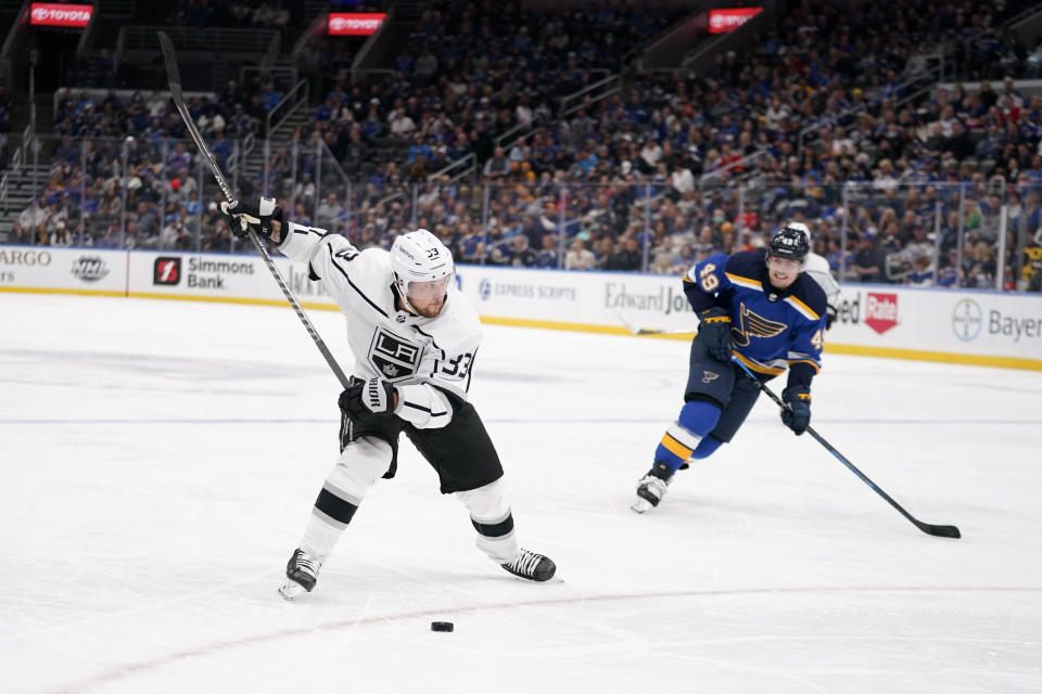 Los Angeles Kings' Viktor Arvidsson (33) shoots as St. Louis Blues' Ivan Barbashev (49) watches during the third period of an NHL hockey game Monday, Oct. 25, 2021, in St. Louis. (AP Photo/Jeff Roberson)