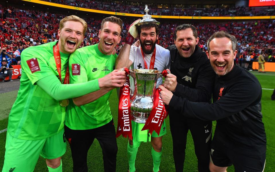 Liverpool's goalkeepers Caoimhin Kelleher, Adrian and Alisson celebrate with John Achterberg and Jack Robinson, their coaches - Getty