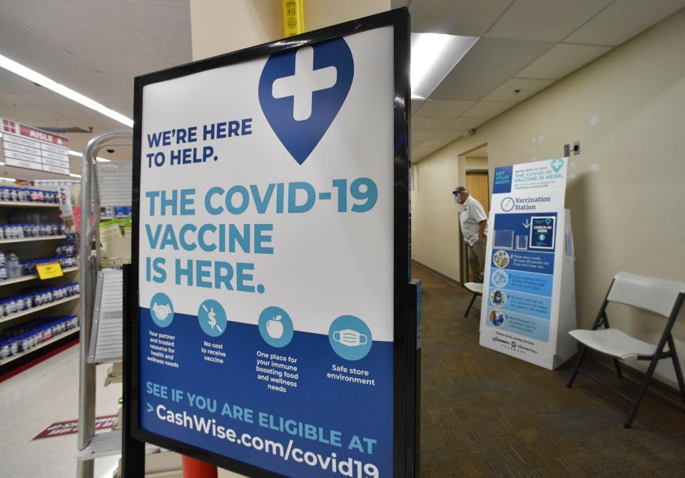 Signs direct people to the vaccination clinic Friday, March 12, 2021, at Cash Wise pharmacy in Waite Park. 