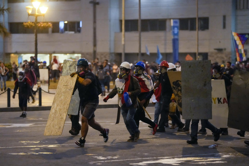Antigovernment protesters clash with police in Lima, Peru, Tuesday, Jan. 24, 2023. Protesters are seeking the resignation of President Dina Boluarte, the release from prison of ousted President Pedro Castillo, immediate elections and justice for demonstrators killed in clashes with police. (AP Photo/Martin Mejia)