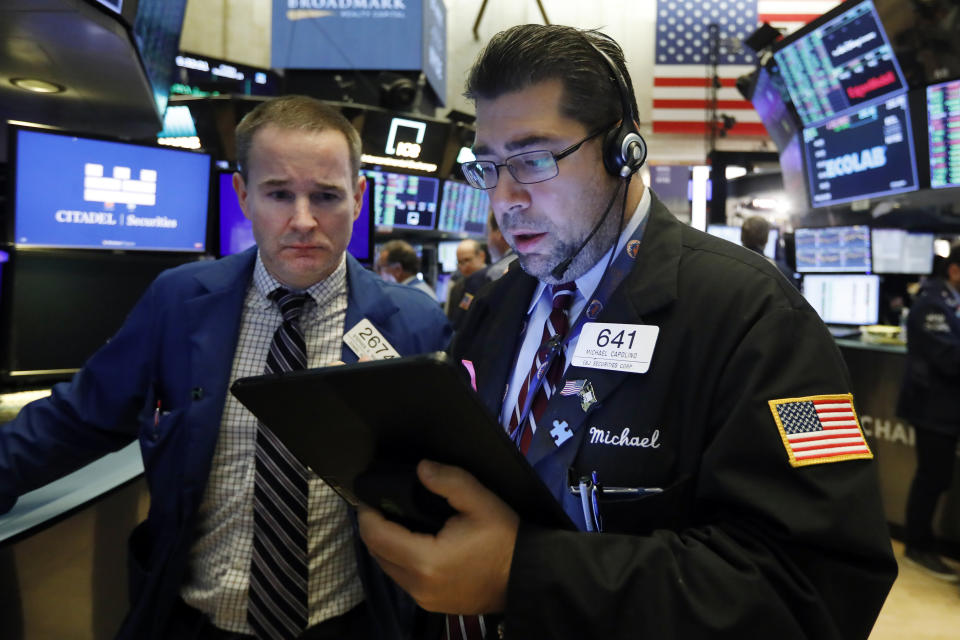 Specialist Stephen Naughton, left, and trader Michael Capolino work on the floor of the New York Stock Exchange, Friday, Nov. 15, 2019. Stocks are opening broadly higher on Wall Street as hopes continued to grow that the U.S. and China were moving closer to a deal on trade. (AP Photo/Richard Drew)