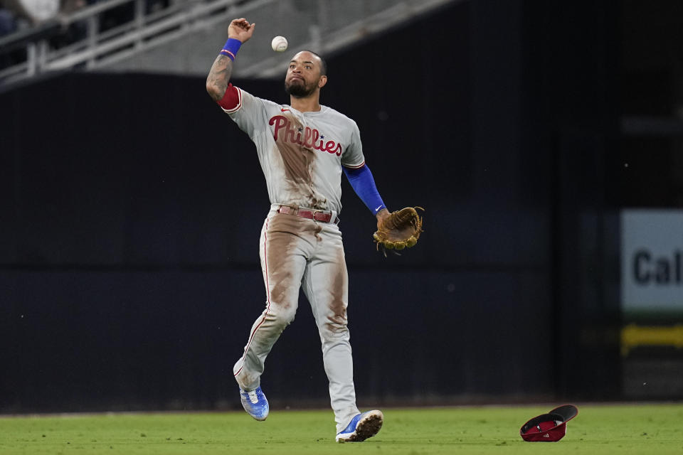 Philadelphia Phillies shortstop Edmundo Sosa tosses the ball in the air after making a leaping catch for the out on San Diego Padres' Ha-Seong Kim during the third inning of a baseball game Tuesday, Sept. 5, 2023, in San Diego. (AP Photo/Gregory Bull)