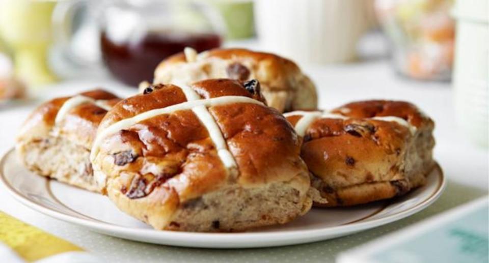 Easter hot cross buns sit on a plate ready to serve