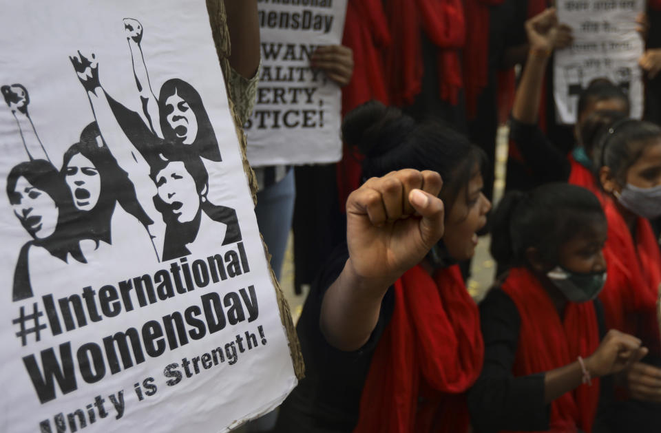 Members of different women's non governmental organizations shout slogans to mark International Women's Day in New Delhi, India, Monday, March 8, 2021. Thousands of female farmers have held sit-ins and a hunger strike in India's capital in protests on International Women's Day against new agricultural laws. (AP Photo/Manish Swarup)